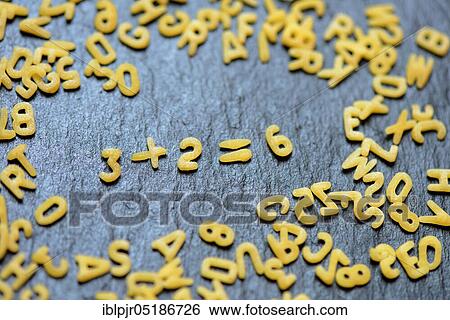 Stock Photograph - Letter noodles form arithmetic, mathematics. Fotosearch