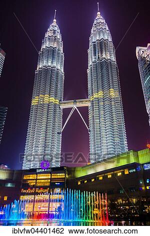 Stock Image - Lighted Petronas Towers with colored fountain at night, Kuala Lumpur, Malaysia, Asia. Fotosearch