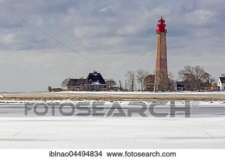 Picture - Lighthouse Flügge on frozen Baltic Sea, Fehmarn Island, Schleswig-Holstein, Germany, Europe. Fotosearch