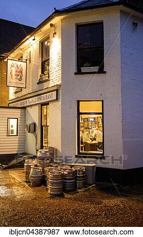 Stock Photo - Lights at a pub with barrels outside the entrance, evening, Whitstable, Kent, England, United Kingdom, Europe. Fotosearch