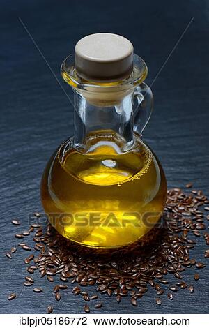 Stock Image - Linseed ( Linum usitatissimum) and linseed oil in bottle. Fotosearch
