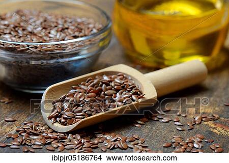 Picture - Linseed ( Linum usitatissimum) in husk and shovel and linseed oil. Fotosearch