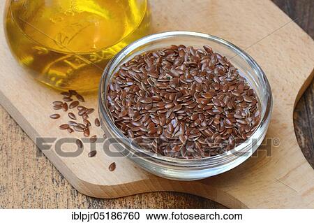 Stock Image - Linseed ( Linum usitatissimum) in husk and linseed oil. Fotosearch