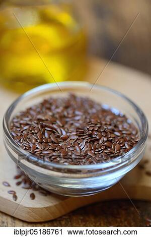 Stock Image - Linseed ( Linum usitatissimum) in husk and linseed oil. Fotosearch