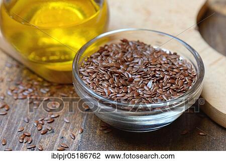 Stock Image - Linseed ( Linum usitatissimum) in husk and linseed oil. Fotosearch