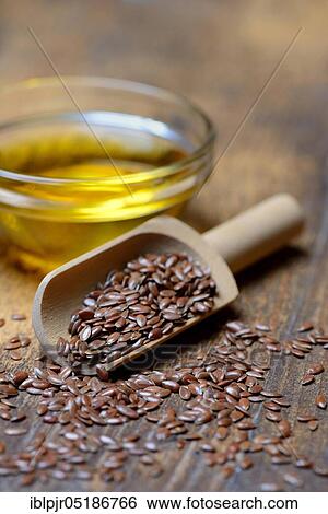 Stock Photograph - Linseed ( Linum usitatissimum) in shovel and linseed oil. Fotosearch