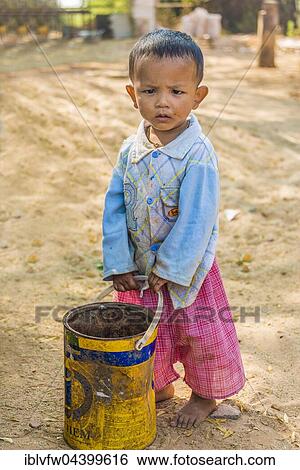 Local child, boy with an old bucket, Bagan, Mandalay Region, Myanmar, Asia View Large Photo Image Stock Photograph - Local child, boy with an old bucket, Bagan, Mandalay Region, Myanmar, Asia. Fotosearch