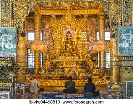 Stock Image - Locals praying, gilded sitting Buddha, Nan Oo Buddha, Nan Oo Buddha Hall, Botataung Pagoda, Buddhist temple, Yangon, Myanmar, Asia. Fotosearch
