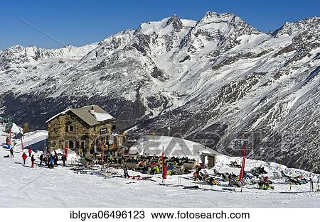 Längflüe hut and skiers in the snowy Swiss Alps, Saas-Fee, Valais, Switzerland, Europe View Large Photo Image Stock Image - Längflüe hut and skiers in the snowy Swiss Alps, Saas-Fee, Valais, Switzerland, Europe. Fotosearch