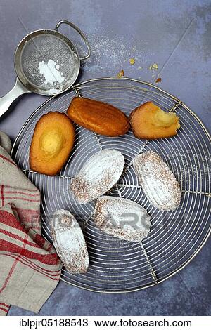 Stock Image - Madeleines on cake grid. Fotosearch