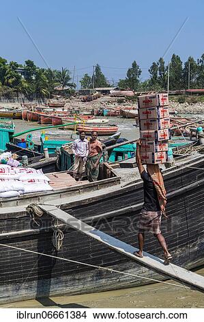 Man carrying a huge load on his head, Chittagong Ship Breaking Yard, Chittagong, Bangladesh, Asia View Large Photo Image Picture - Man carrying a huge load on his head, Chittagong Ship Breaking Yard, Chittagong, Bangladesh, Asia. Fotosearch