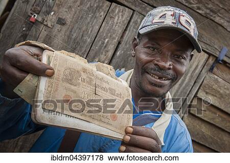 Stock Photo - Man holding German bank note, old German paper money, Fundong, Northwest Region, Cameroon, Africa. Fotosearch