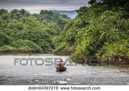 Man in dugout canoe, navigating river, Foumbam, West Region, Cameroon, Africa View Large Photo Image Stock Photo - Man in dugout canoe, navigating river, Foumbam, West Region, Cameroon, Africa. Fotosearch