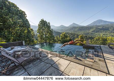 Man jumps into a swimming pool, Munduk, Bali, Indonesia, Asia View Large Photo Image Stock Photograph - Man jumps into a swimming pool, Munduk, Bali, Indonesia, Asia. Fotosearch
