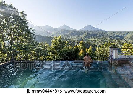 Man looking over the landscape, pool, Munduk, Bali, Indonesia, Asia View Large Photo Image Stock Photography - Man looking over the landscape, pool, Munduk, Bali, Indonesia, Asia. Fotosearch