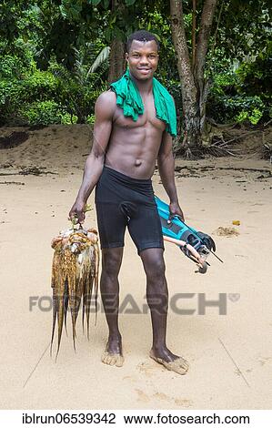 Man presenting his fresh caught squid, beach Praia do Inhame, south coast of Sao Tome, Sao Tome and Principe, Atlantic ocean, Africa View Large Photo Image Stock Image - Man presenting his fresh caught squid, beach Praia do Inhame, south coast of Sao Tome, Sao Tome and Principe, Atlantic ocean, Africa. Fotosearch