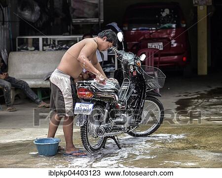 Man washes his moped, Phnom Penh, Cambodia, Asia View Large Photo Image Stock Image - Man washes his moped, Phnom Penh, Cambodia, Asia. Fotosearch