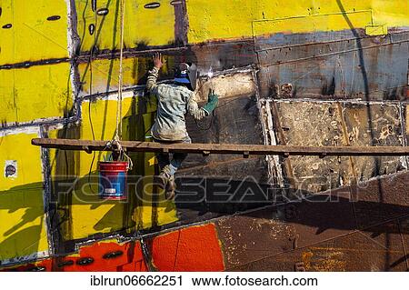 Man welding on a ship, shipwreck cemetery, Port of Dhaka, Bangladesh, Asia View Large Photo Image Stock Image - Man welding on a ship, shipwreck cemetery, Port of Dhaka, Bangladesh, Asia. Fotosearch