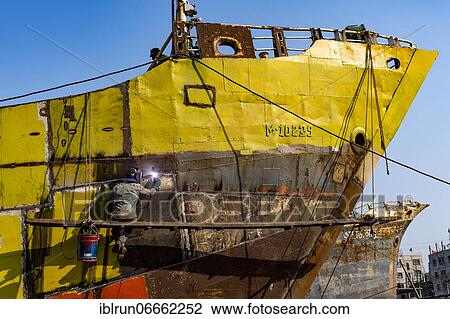 Man welding on a ship, shipwreck cemetery, Port of Dhaka, Bangladesh, Asia View Large Photo Image Stock Image - Man welding on a ship, shipwreck cemetery, Port of Dhaka, Bangladesh, Asia. Fotosearch