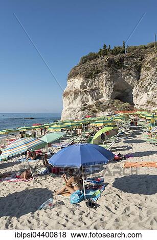 Many people with colorful sunshades at Lido Isola Bella Beach, Tropea, Calabria, Italy, Europe View Large Photo Image Stock Photo - Many people with colorful sunshades at Lido Isola Bella Beach, Tropea, Calabria, Italy, Europe. Fotosearch