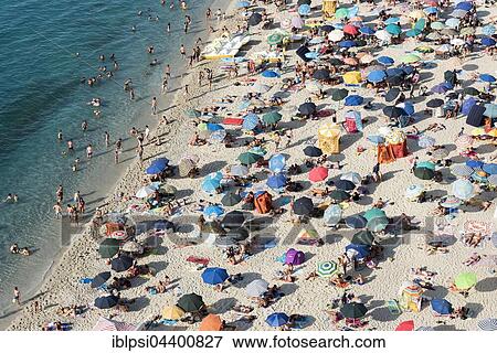 Many people with colorful sunshades at Tropea Beach, Calabria, Italy, Europe View Large Photo Image Stock Photo - Many people with colorful sunshades at Tropea Beach, Calabria, Italy, Europe. Fotosearch