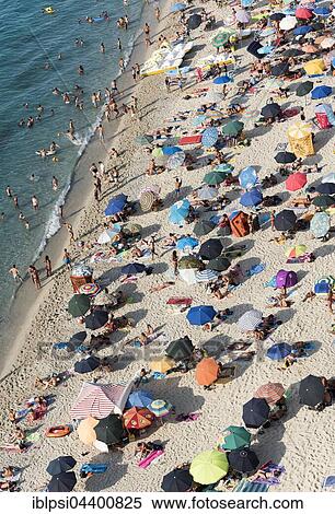 Many people with colorful sunshades at Tropea Beach, Calabria, Italy, Europe View Large Photo Image Stock Photography - Many people with colorful sunshades at Tropea Beach, Calabria, Italy, Europe. Fotosearch