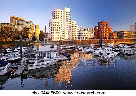 Stock Image - Marina with Gehry buildings in the evening light, Düsseldorf, North Rhine-Westphalia, Germany, Europe. Fotosearch