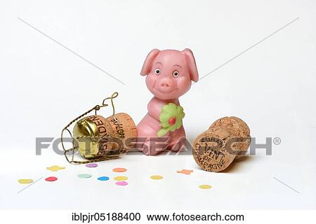 Stock Image - Marzipan pig, lucky pig made of marzipan and champagne cork, New Year, New Year's wishes. Fotosearch