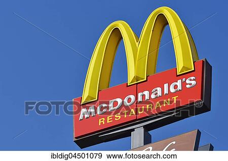 McDonalds sign against a blue sky View Large Photo Image Stock Photo - McDonalds sign against a blue sky. Fotosearch