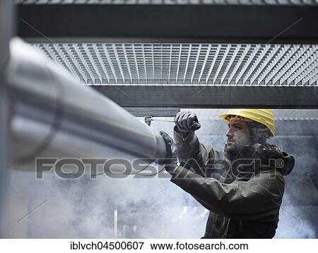 Mechanic, technician fixing mount of a pipeline, Austria, Europe View Large Photo Image Stock Photo - Mechanic, technician fixing mount of a pipeline, Austria, Europe. Fotosearch