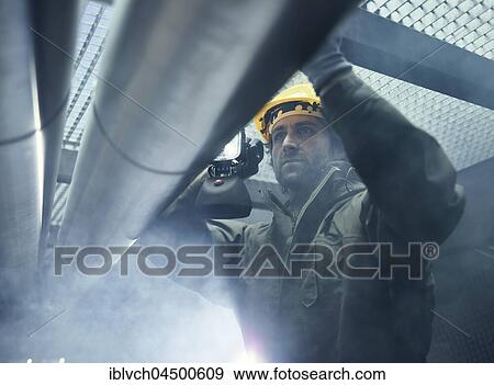 Mechanic with flashlight checking a pipeline, Austria, Europe View Large Photo Image Stock Photo - Mechanic with flashlight checking a pipeline, Austria, Europe. Fotosearch