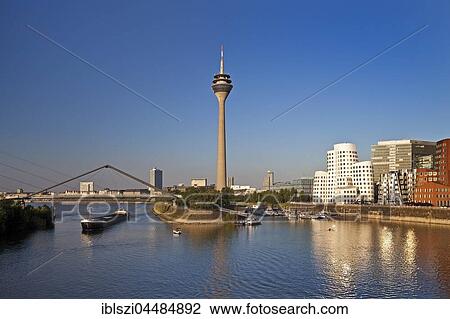 Stock Image - Medienhafen with Rheinkniebrücke, Rhine Tower and Neuer Zollhof, Düsseldorf, North Rhine-Westphalia, Germany, Europe. Fotosearch