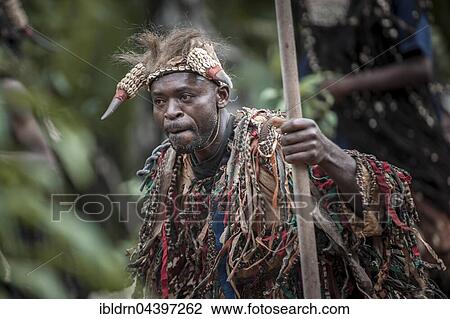 Stock Image - Men of the ethnic group of the Bamileke with traditional masks, Dance of Death in honor of a deceased person, Badenkop, West Region, Cameroon, Africa. Fotosearch