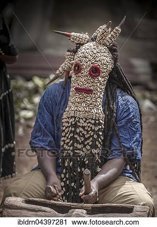 Stock Image - Men of the ethnic group of the Bamileke with traditional masks, Dance of Death in honor of a deceased person, Badenkop, West Region, Cameroon, Africa. Fotosearch