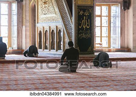 Stock Image - Men Praying, Blue Mosque, Istanbul, Turkey, Asia. Fotosearch