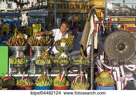 Merchant with offerings in temple complex at Golden Rock Kyaiktiyo Pagoda, Kyaikto, Myanmar, Asia View Large Photo Image Picture - Merchant with offerings in temple complex at Golden Rock Kyaiktiyo Pagoda, Kyaikto, Myanmar, Asia. Fotosearch