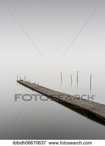 Metal footbridge at Nebel in Kleiner Schwielochsee, Goyatz, Brandenburg, Germany, Europe View Large Photo Image Stock Photo - Metal footbridge at Nebel in Kleiner Schwielochsee, Goyatz, Brandenburg, Germany, Europe. Fotosearch