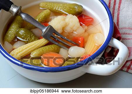 Picture - Mixed pickles with carrots, cauliflower, gherkins, onions and corn onions in a bowl with fork, pickled, pickled, pickled gherkin. Fotosearch