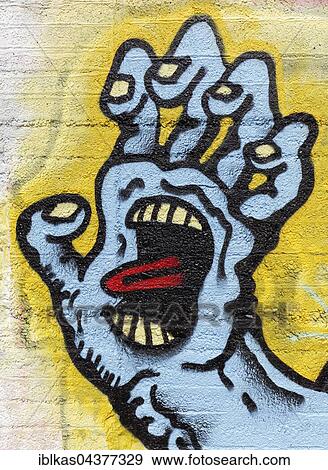 Monster hand, grasping, face in palm, tongue stuck out, symbolic, graffiti, street art, Duisburg, North Rhine-Westphalia, Germany, Europe View Large Photo Image Stock Photo - Monster hand, grasping, face in palm, tongue stuck out, symbolic, graffiti, street art, Duisburg, North Rhine-Westphalia, Germany, Europe. Fotosearch