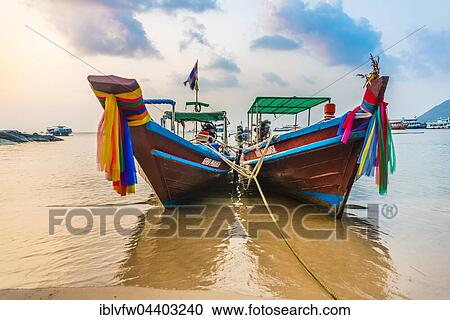 Moored colorful traditional long-tail boats on sandy beach, Ko Pha-ngan, Thailand, Asia View Large Photo Image Stock Image - Moored colorful traditional long-tail boats on sandy beach, Ko Pha-ngan, Thailand, Asia. Fotosearch