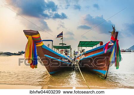 Moored colorful traditional long-tail boats on sandy beach, Ko Pha-ngan, Thailand, Asia View Large Photo Image Stock Photo - Moored colorful traditional long-tail boats on sandy beach, Ko Pha-ngan, Thailand, Asia. Fotosearch
