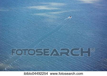 Motor boat on lake, crossing waves, blue water, Koszalin, Baltic Coast, West Pomerania Province, Poland, Europe View Large Photo Image Picture - Motor boat on lake, crossing waves, blue water, Koszalin, Baltic Coast, West Pomerania Province, Poland, Europe. Fotosearch