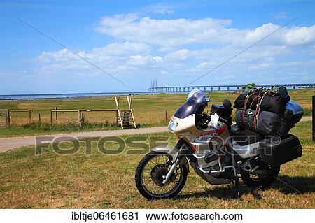 Motorcycle camping, loaded motorcycle, behind Öresund bridge, near Malmö, Sweden, Europe View Large Photo Image Stock Image - Motorcycle camping, loaded motorcycle, behind Öresund bridge, near Malmö, Sweden, Europe. Fotosearch