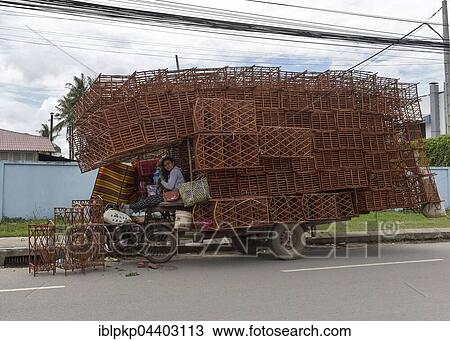 Stock Image - Motorcycle with fully loaded trailer, loaded with shelves, Phnom Penh, Cambodia, Asia. Fotosearch