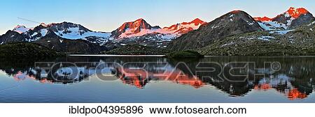 Mount Zuckerhütl and the Stubai glacier at sunrise, reflected at lake Mutterberger See, Stubai valley, Alps, Tyrol, Austria, Europe View Large Photo Image Stock Photograph - Mount Zuckerhütl and the Stubai glacier at sunrise, reflected at lake Mutterberger See, Stubai valley, Alps, Tyrol, Austria, Europe. Fotosearch