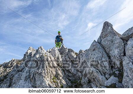 Stock Image - Mountaineer climbs a secured via ferrata, Mittenwalder Höhenweg, Karwendel Mountains, Mittenwald, Bavaria, Germany, Europe. Fotosearch