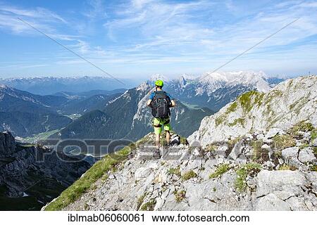 Mountaineer climbs on a secured fixed rope route, Mittenwalder Höhenweg, view into the Isar valley near Mittenwald, Karwendel Mountains, Mittenwald, Bavaria, Germany, Europe View Large Photo Image Stock Image - Mountaineer climbs on a secured fixed rope route, Mittenwalder Höhenweg, view into the Isar valley near Mittenwald, Karwendel Mountains, Mittenwald, Bavaria, Germany, Europe. Fotosearch
