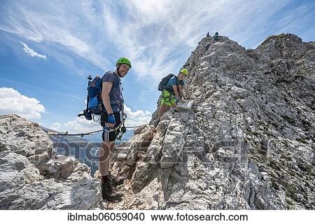 Stock Image - Mountaineer on a ridge on a secured fixed rope route, Mittenwalder Höhenweg, Karwendel Mountains, Mittenwald, Bavaria, Germany, Europe. Fotosearch