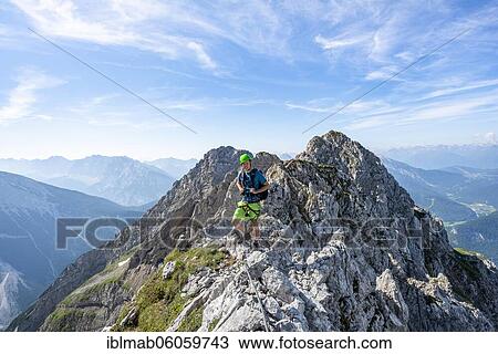 Mountaineer on a ridge on a secured fixed rope route, Mittenwalder Höhenweg, Karwendel Mountains, Mittenwald, Bavaria, Germany, Europe View Large Photo Image Stock Image - Mountaineer on a ridge on a secured fixed rope route, Mittenwalder Höhenweg, Karwendel Mountains, Mittenwald, Bavaria, Germany, Europe. Fotosearch