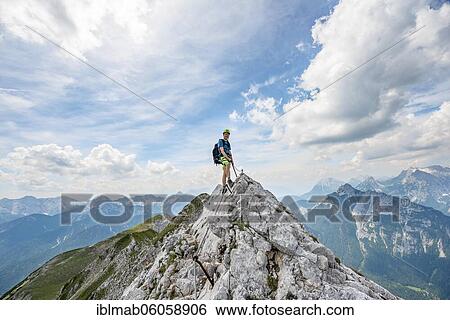 Mountaineer on a ridge on a secured fixed rope route, Mittenwalder Höhenweg, view of mountain panorama, Karwendel Mountains, Mittenwald, Bavaria, Germany, Europe View Large Photo Image Stock Photograph - Mountaineer on a ridge on a secured fixed rope route, Mittenwalder Höhenweg, view of mountain panorama, Karwendel Mountains, Mittenwald, Bavaria, Germany, Europe. Fotosearch